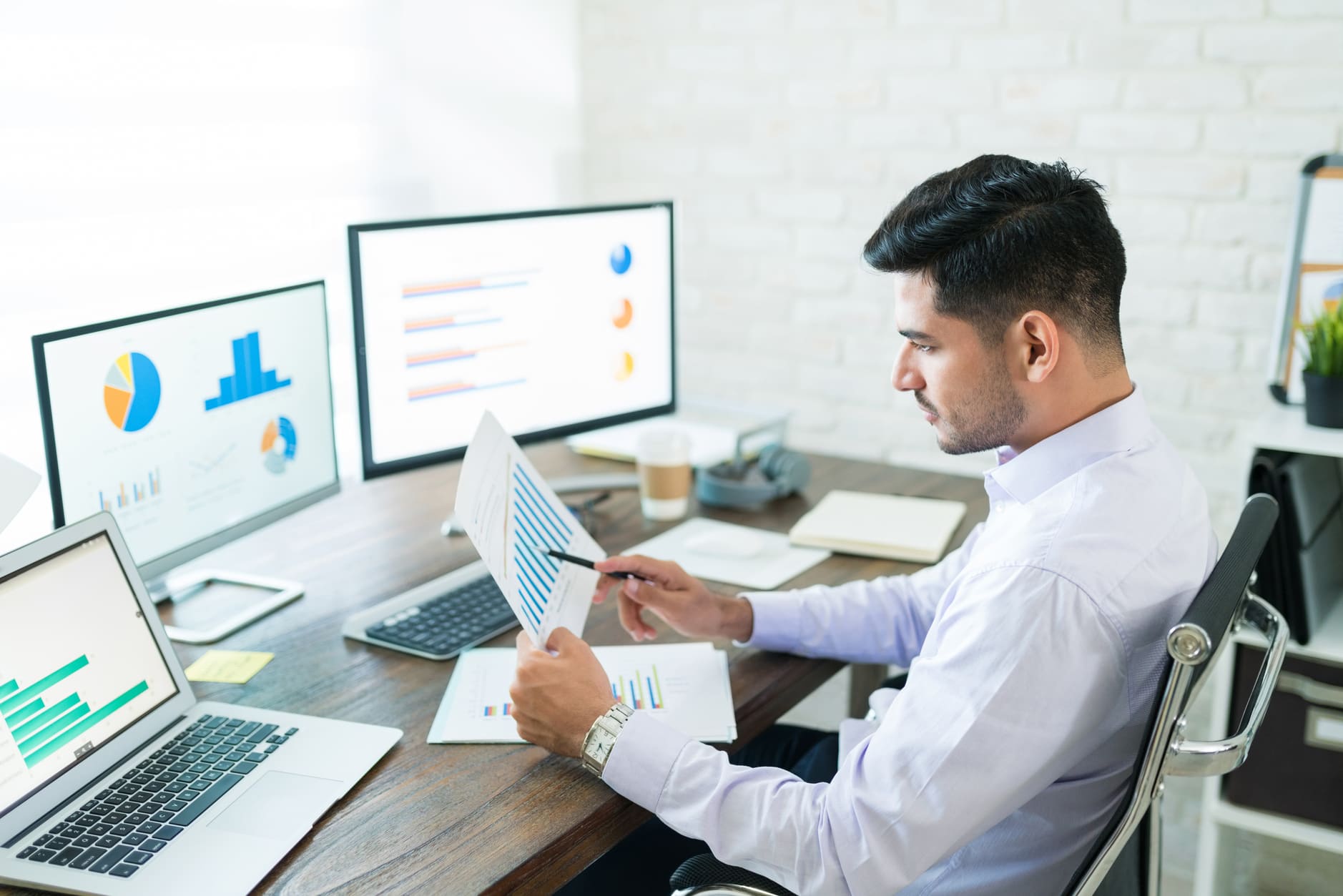 handsome-latin-businessman-examining-sales
